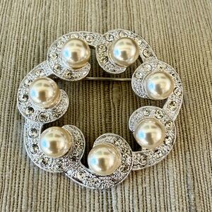 Simulated Pearls and Rhinestones in a silver color setting.